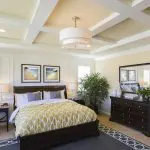 Bedroom with soft cream walls and coffered ceiling for choosing the right paint finish