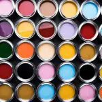 Open paint cans in an array of colors for choosing when to repaint interior walls