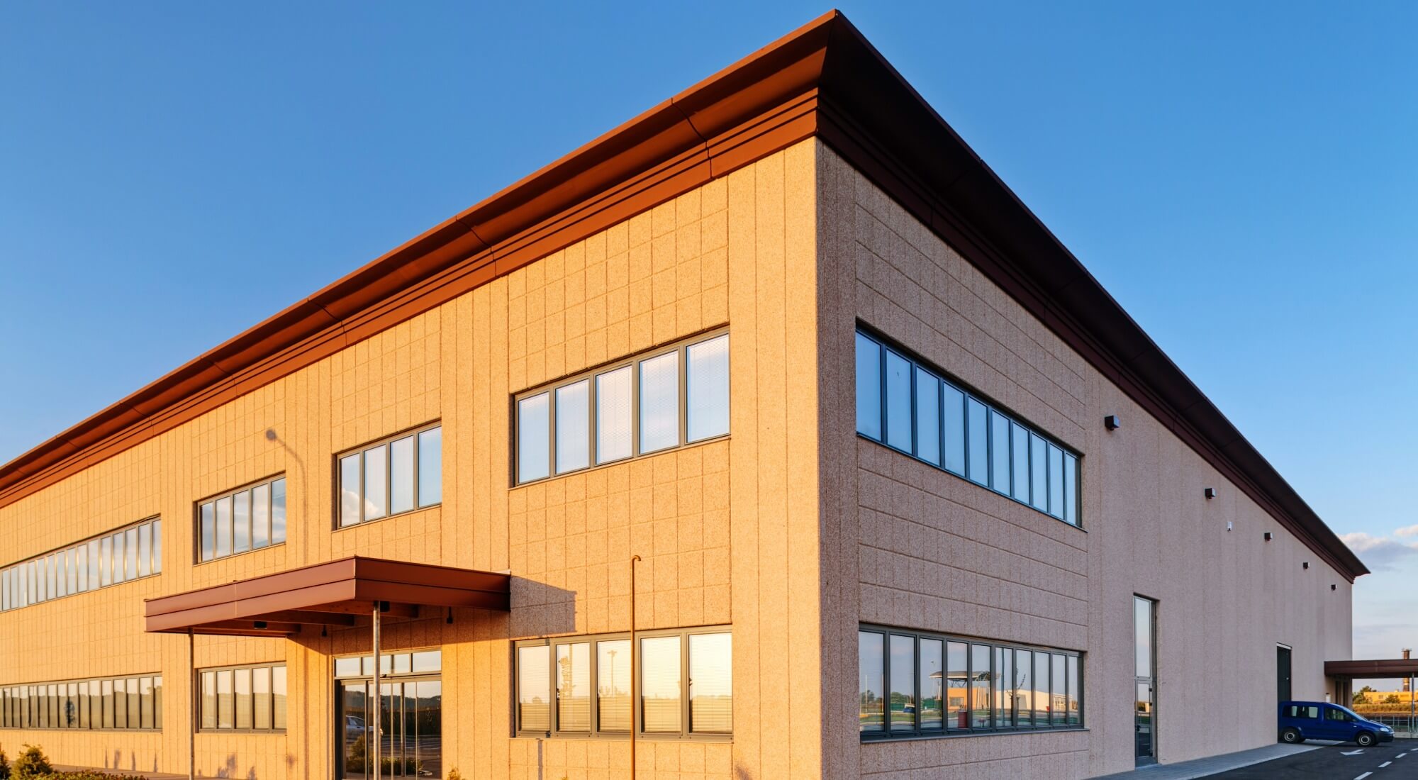 Tan industrial building with dark trim, painters in Pinehurst, NC
