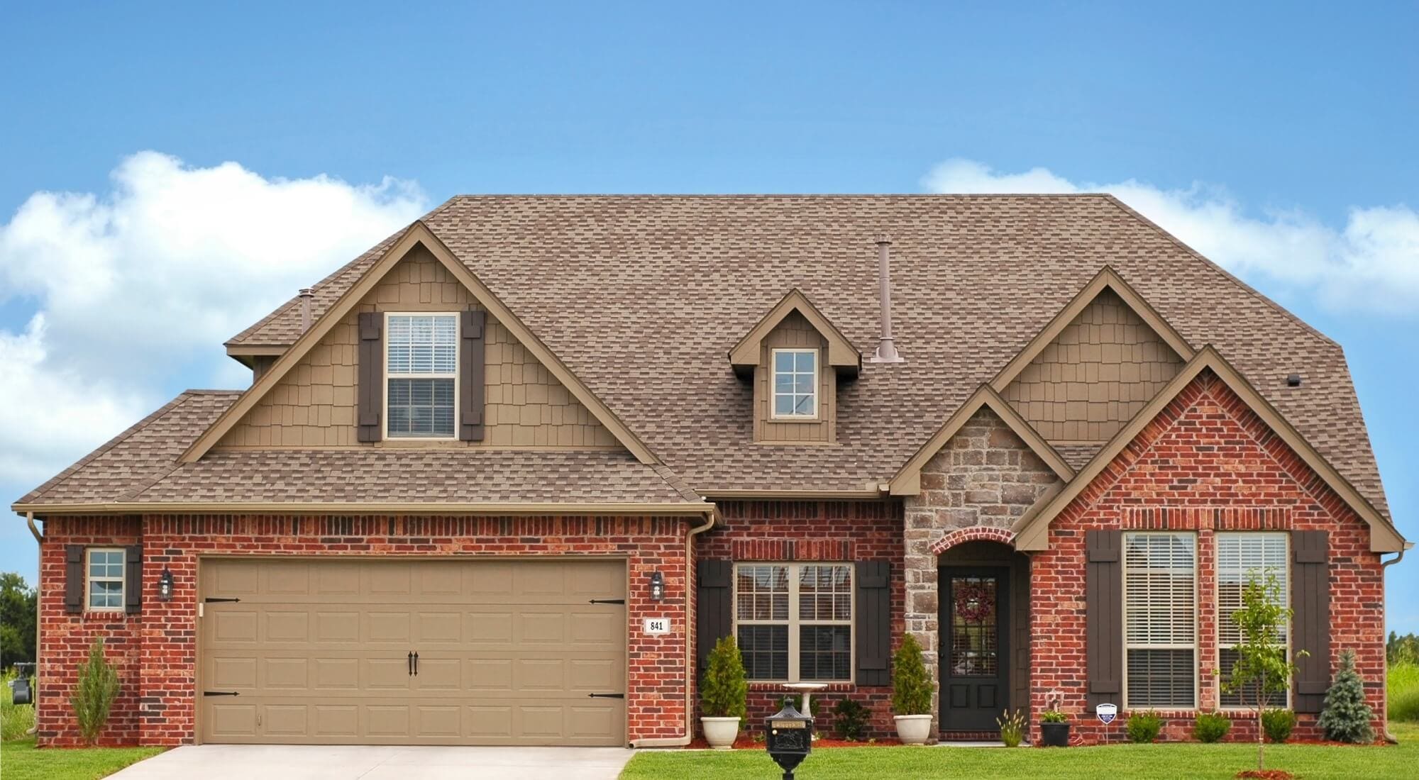 Brick home with tan siding, residential painting in Southern Pines, NC