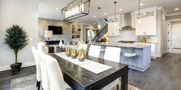 Open dining room and kitchen with white cabinetry and dark wood table