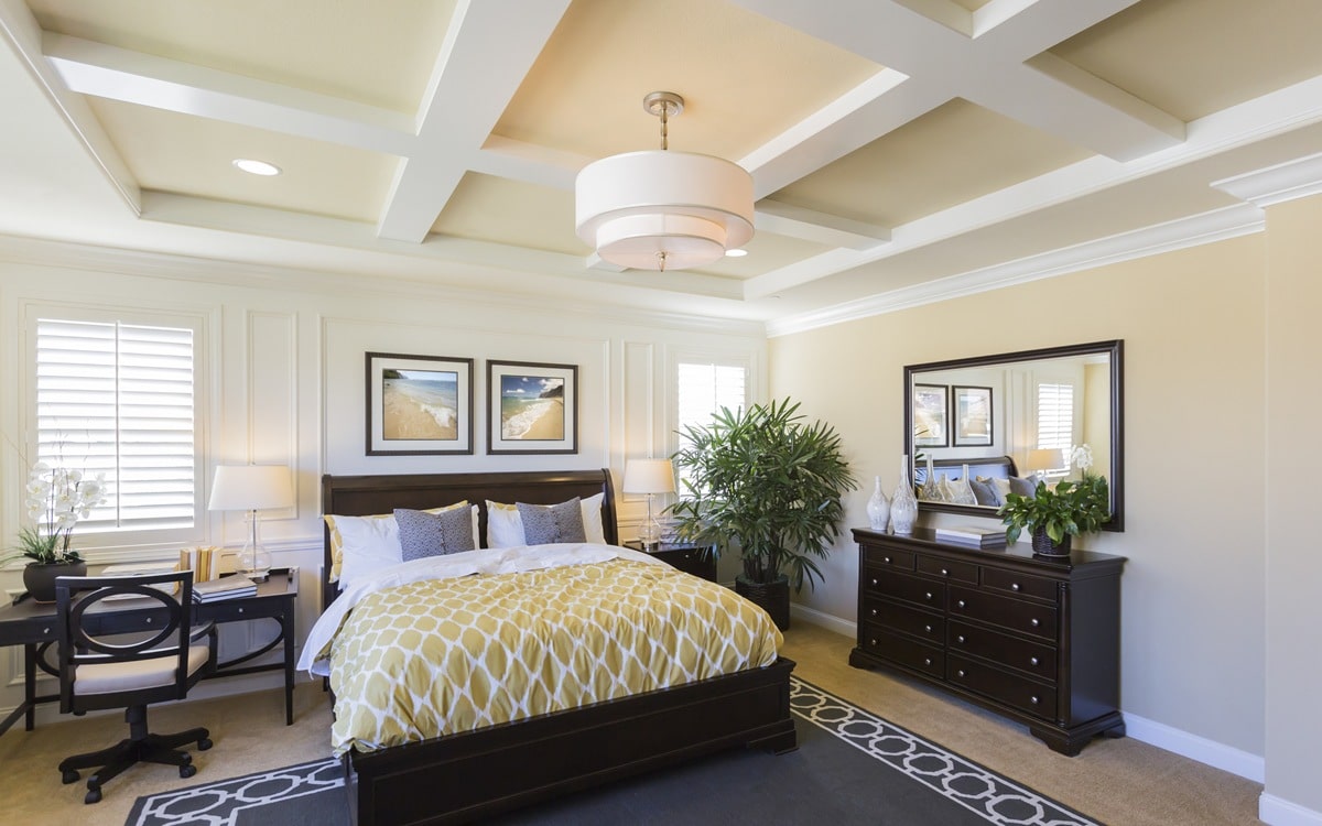 Bedroom with soft cream walls and coffered ceiling for choosing the right paint finish